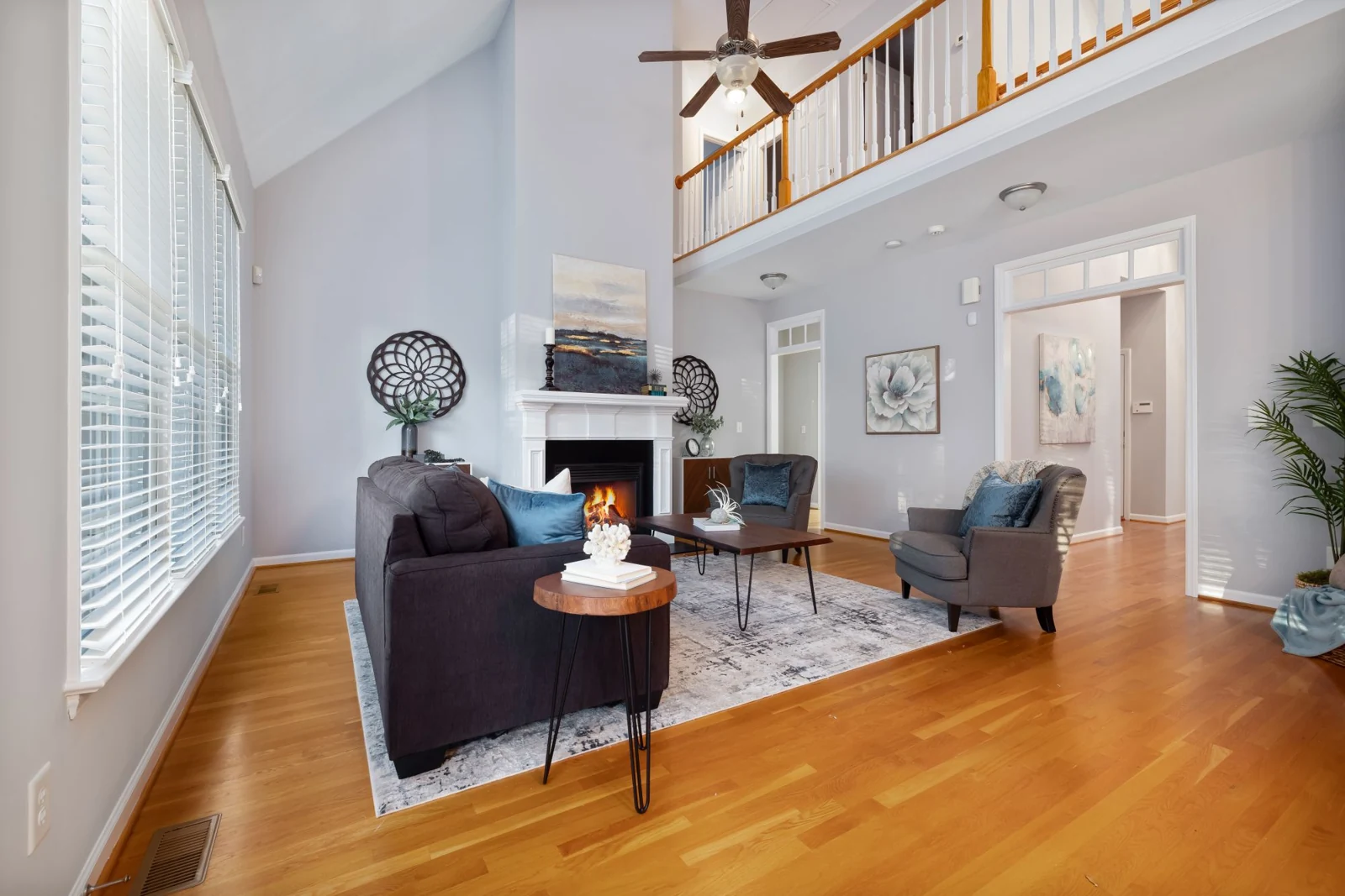 Fireplace in a bright living room with high windows